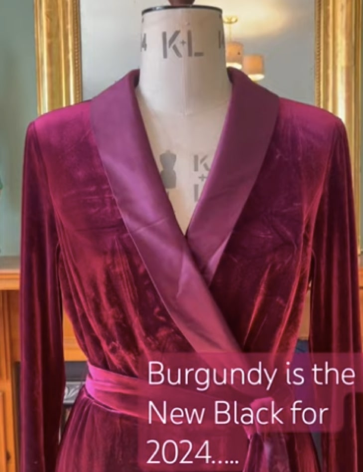 A velvet burgundy dress on a mannequin